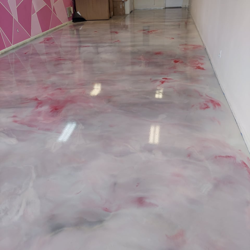 This picture shows a metallic epoxy system installed to match a kid's salon.  